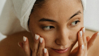 a woman washes her face with non-toxic skincare